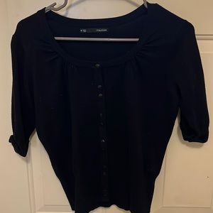 Black button down light weight sweater worn as a top .